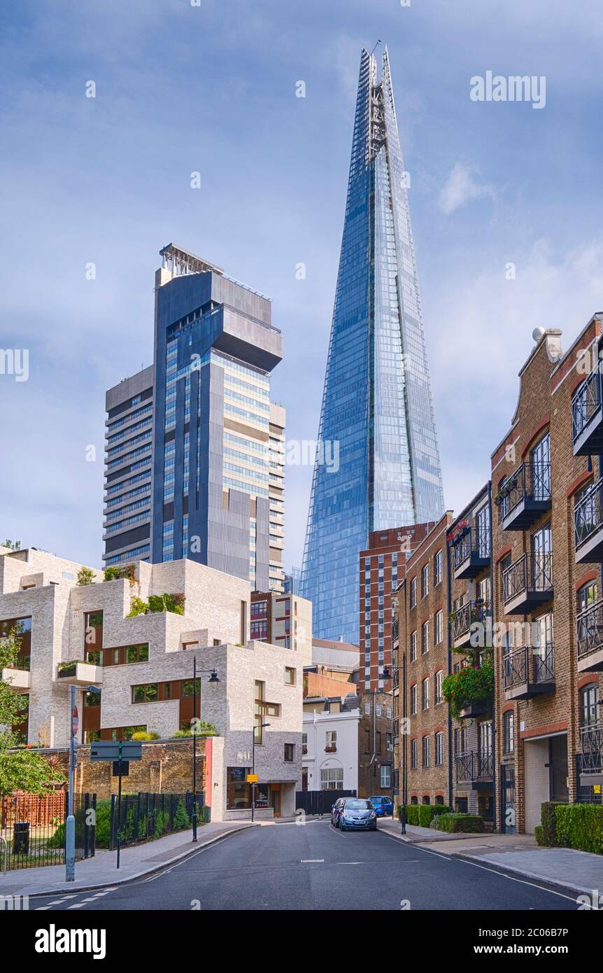 The imposing towers of Guys Hospital (left) and the Shard (right) seen from a nearby residential street in Bermondsey, south London. Stock Photo