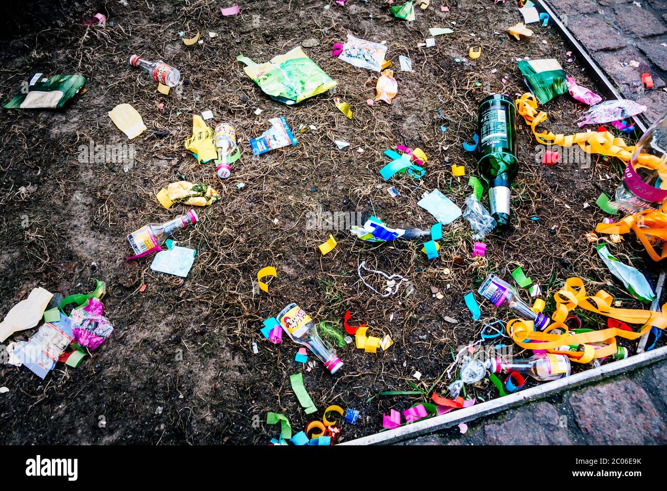 Empty beer bottles, chocolate packagings, festival decorations and other garbage are lying on