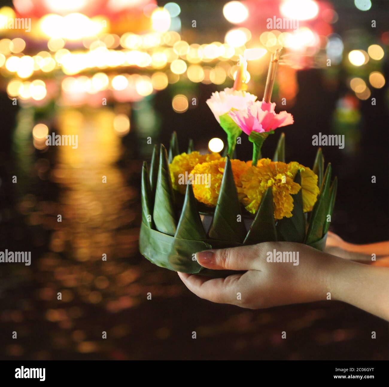 Woman holding kratong in her hands Stock Photo