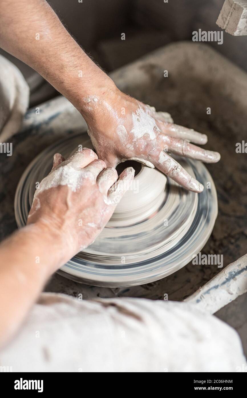 A ceramicist working on a potters wheel a studio in County Kerry, Ireland. Stock Photo