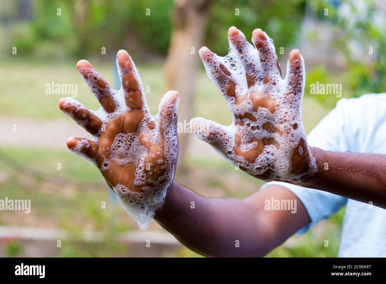 a man washing his hands by soap to maintain hygiene.stay healthy.avoid germ and virus. Stock Photo