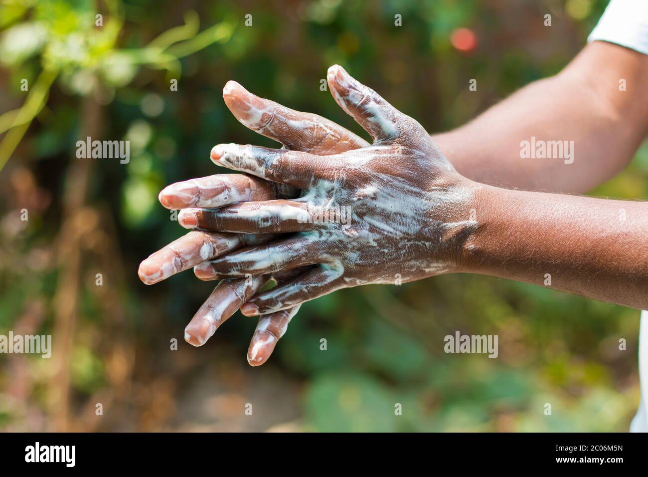 a man washing his hands by soap to maintain hygiene.stay healthy.avoid germ and virus. Stock Photo