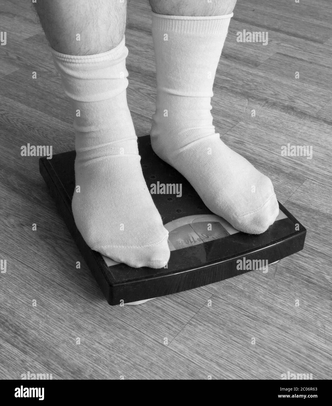 Legs in white socks stand on mechanical scales of blue color (front view  Stock Photo - Alamy