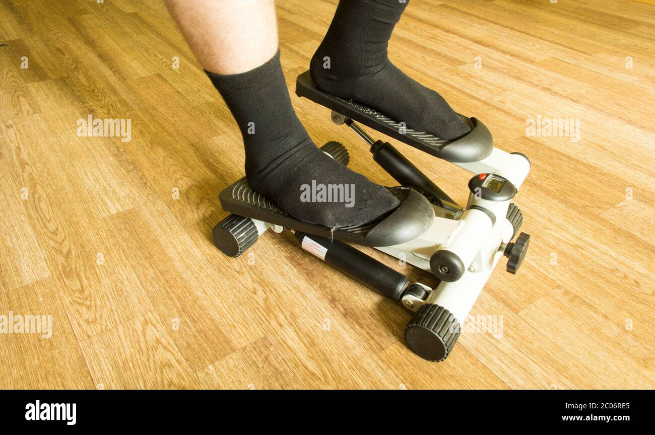 Men's legs in black socks stand on a stepper (side view Stock Photo Alamy