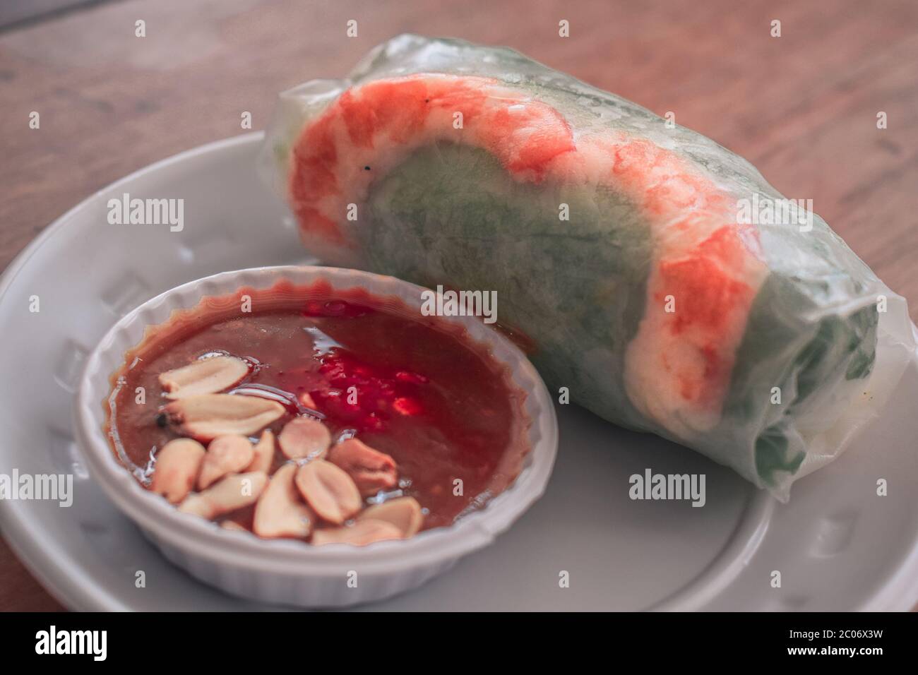 Fresh Vietnamese spring roll with shrimps, tomato dip and peanuts Stock Photo
