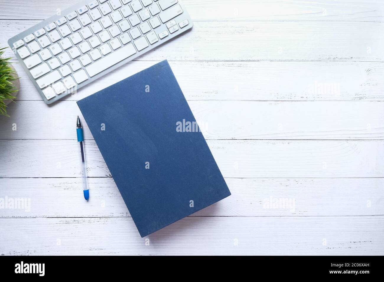 book with empty cover, pen and keyboard on table  Stock Photo