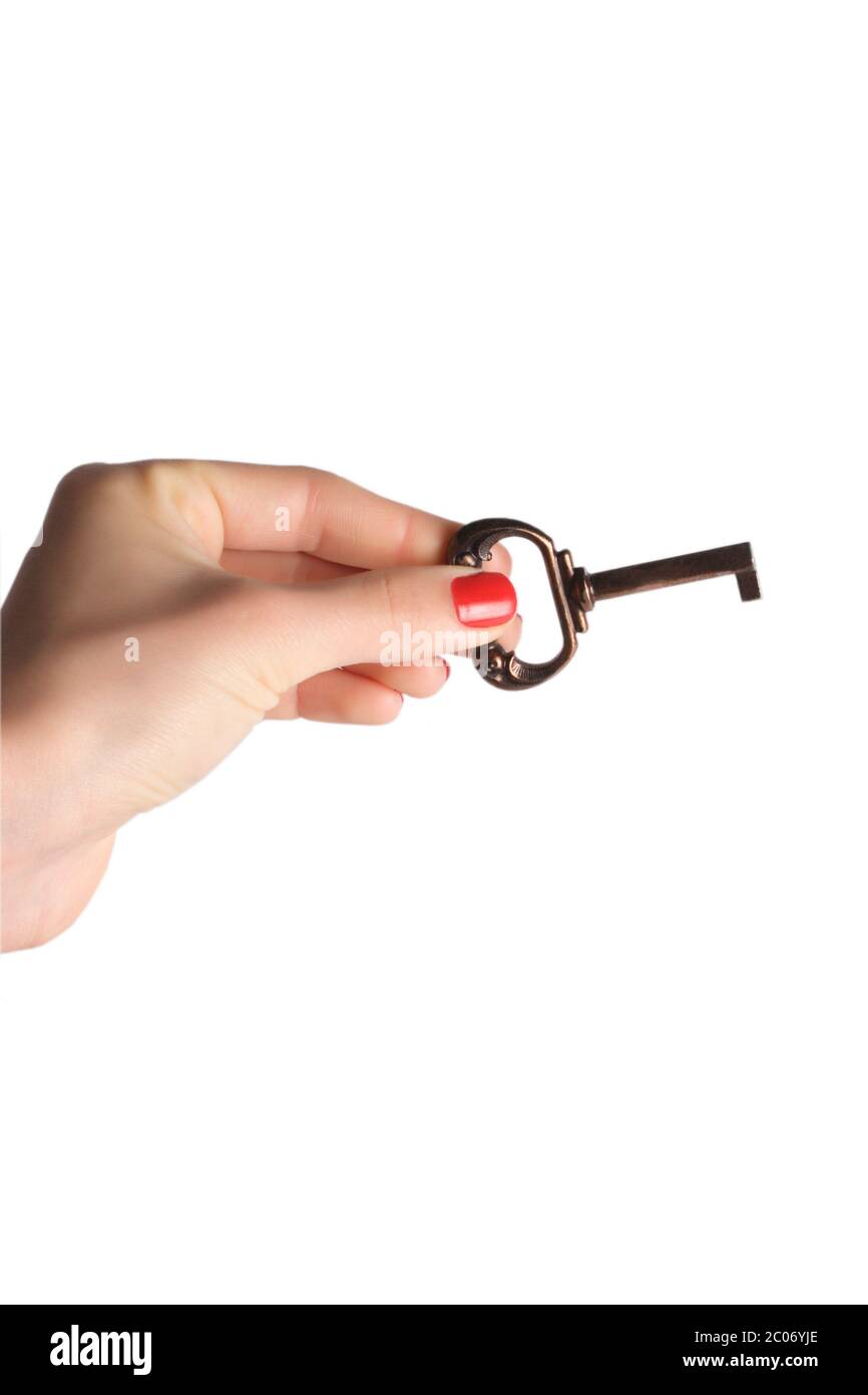 Woman's hand holding a key on white background Stock Photo - Alamy