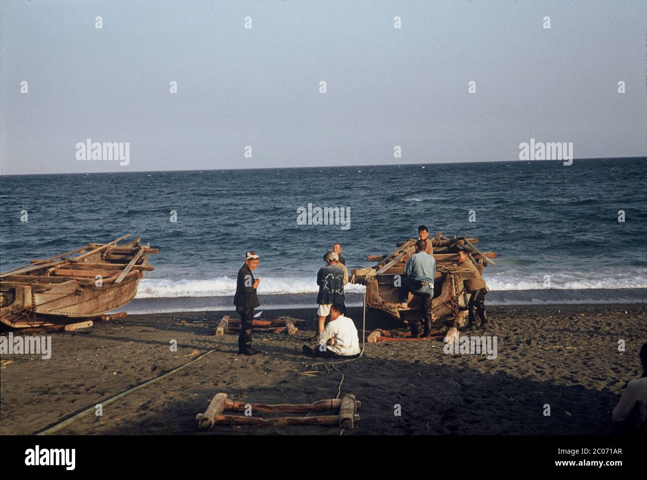 [ 1950s Japan - Fishermen and Fishing Boats ] — Japanese fishermen and their boats on a beach in Odawara, Kanagawa Prefecture in March 1954 (Showa 29).  20th century vintage slide film. Stock Photo