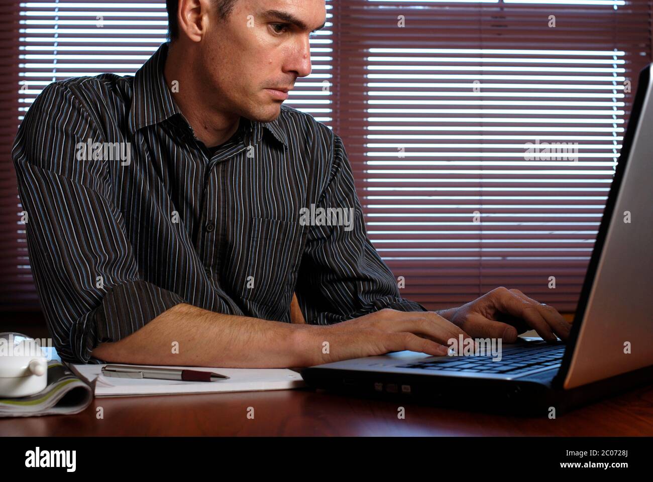 Man working from home on laptop computer Stock Photo