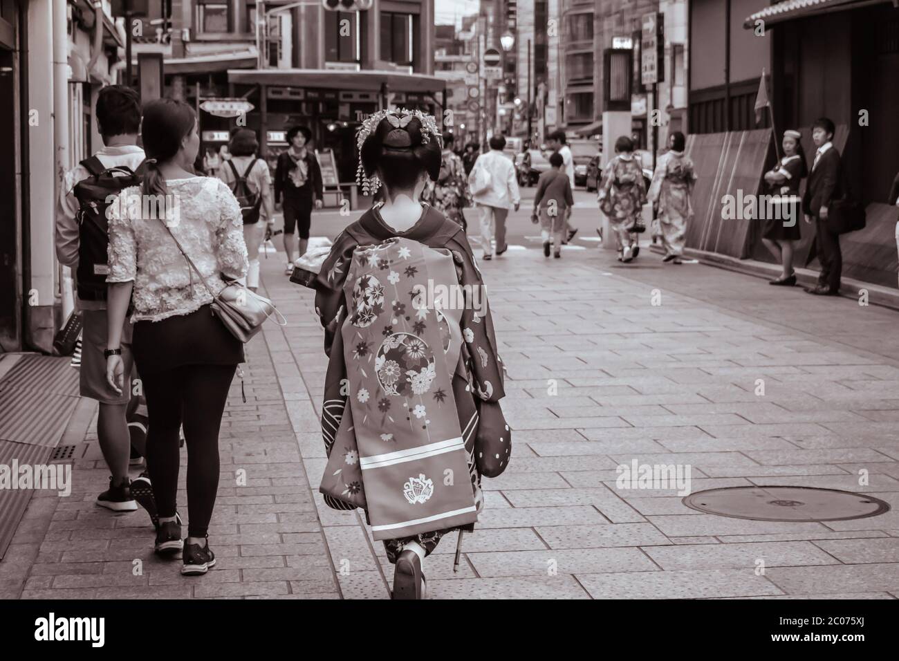 Japanese Maiko (Geisha in training) walking down the street in Gion Kyoto Japan Stock Photo