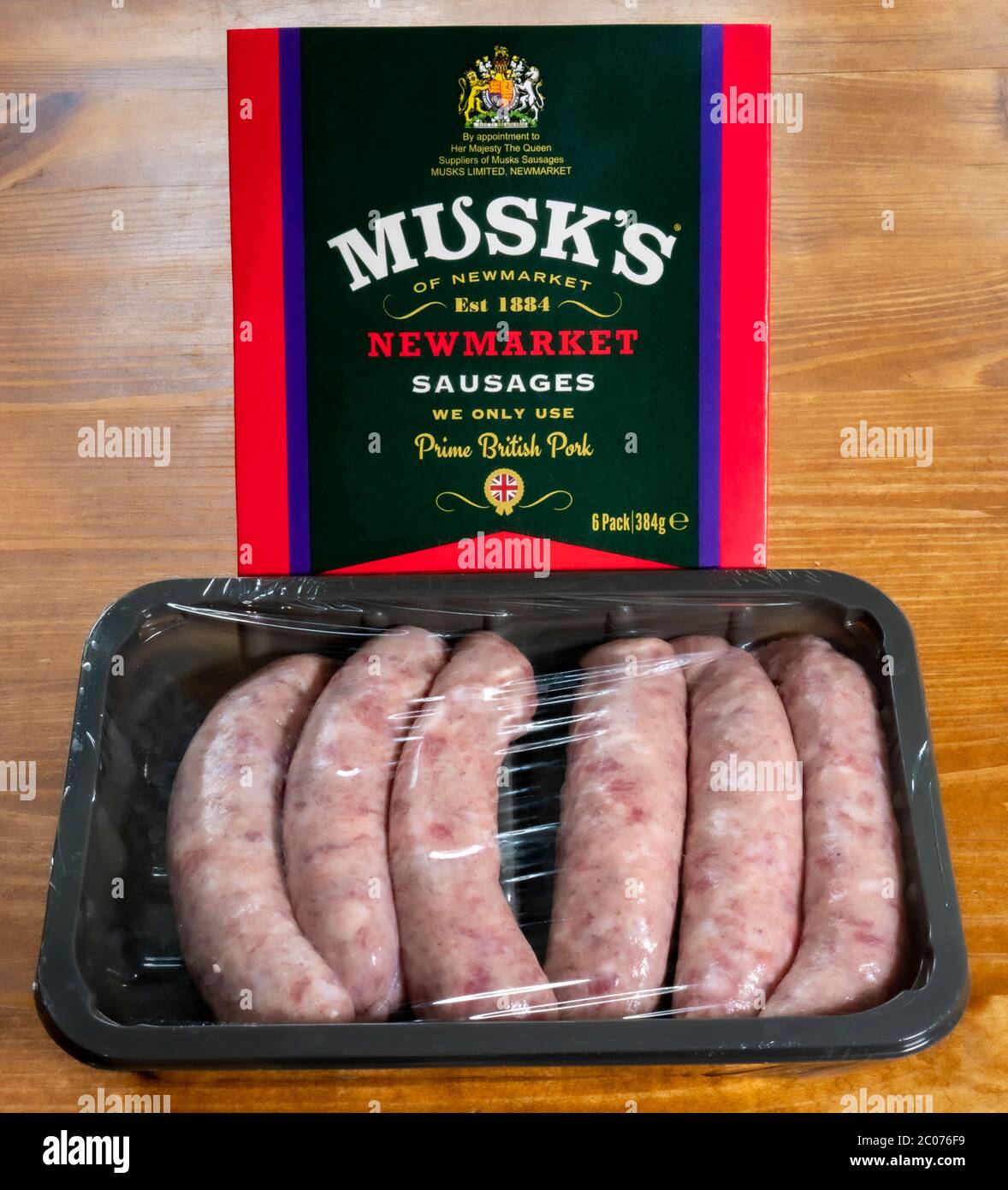 Musk’s Newmarket Sausages. Cellophane covered tray of six uncooked prime British pork sausages, in front of the Musk's cardboard sleeve. Stock Photo