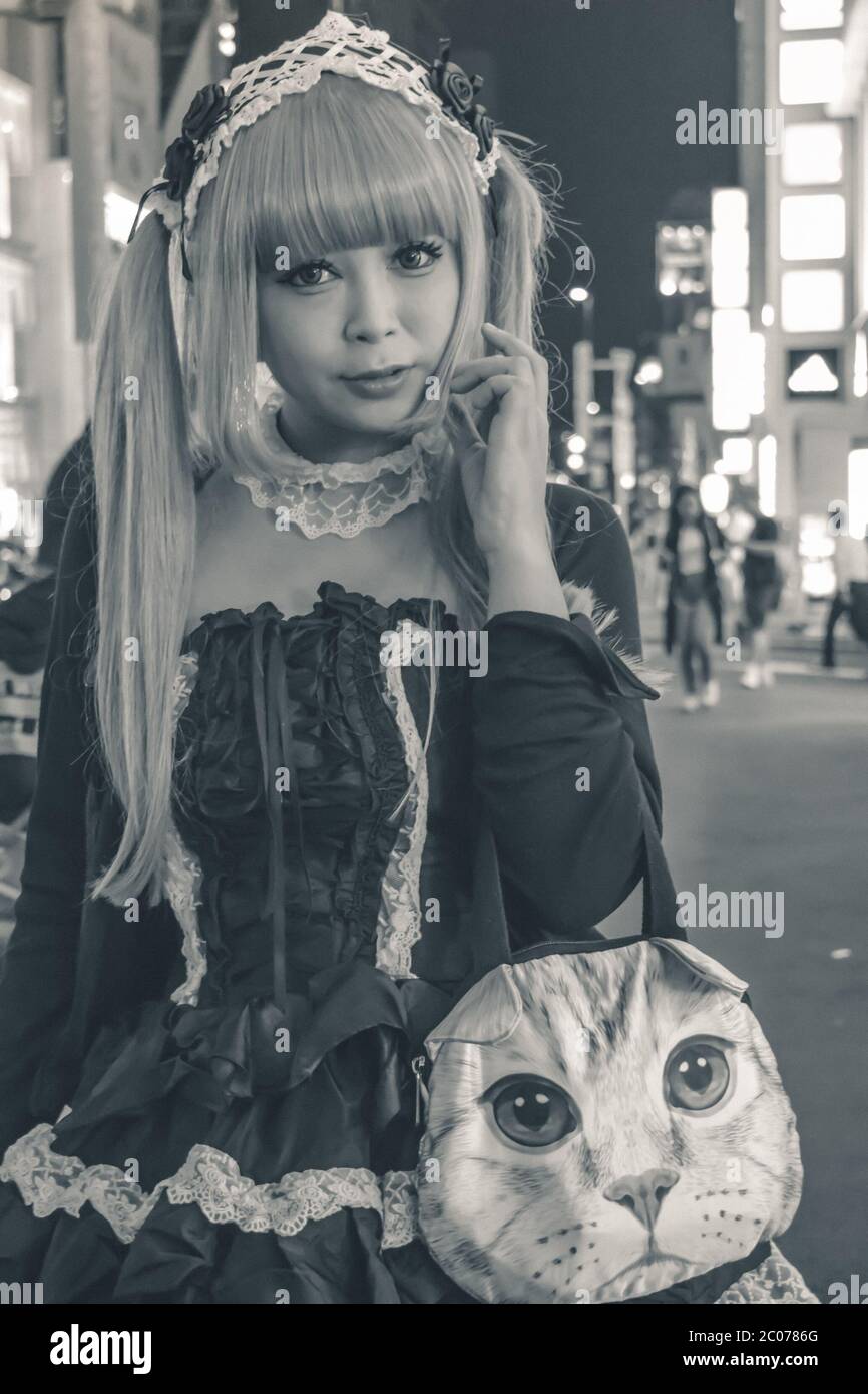 Unidentified Japanese girl in black costume and blonde hair walking at Harajuku in Tokyo Japan (example of typical Japanese cosplay) Stock Photo