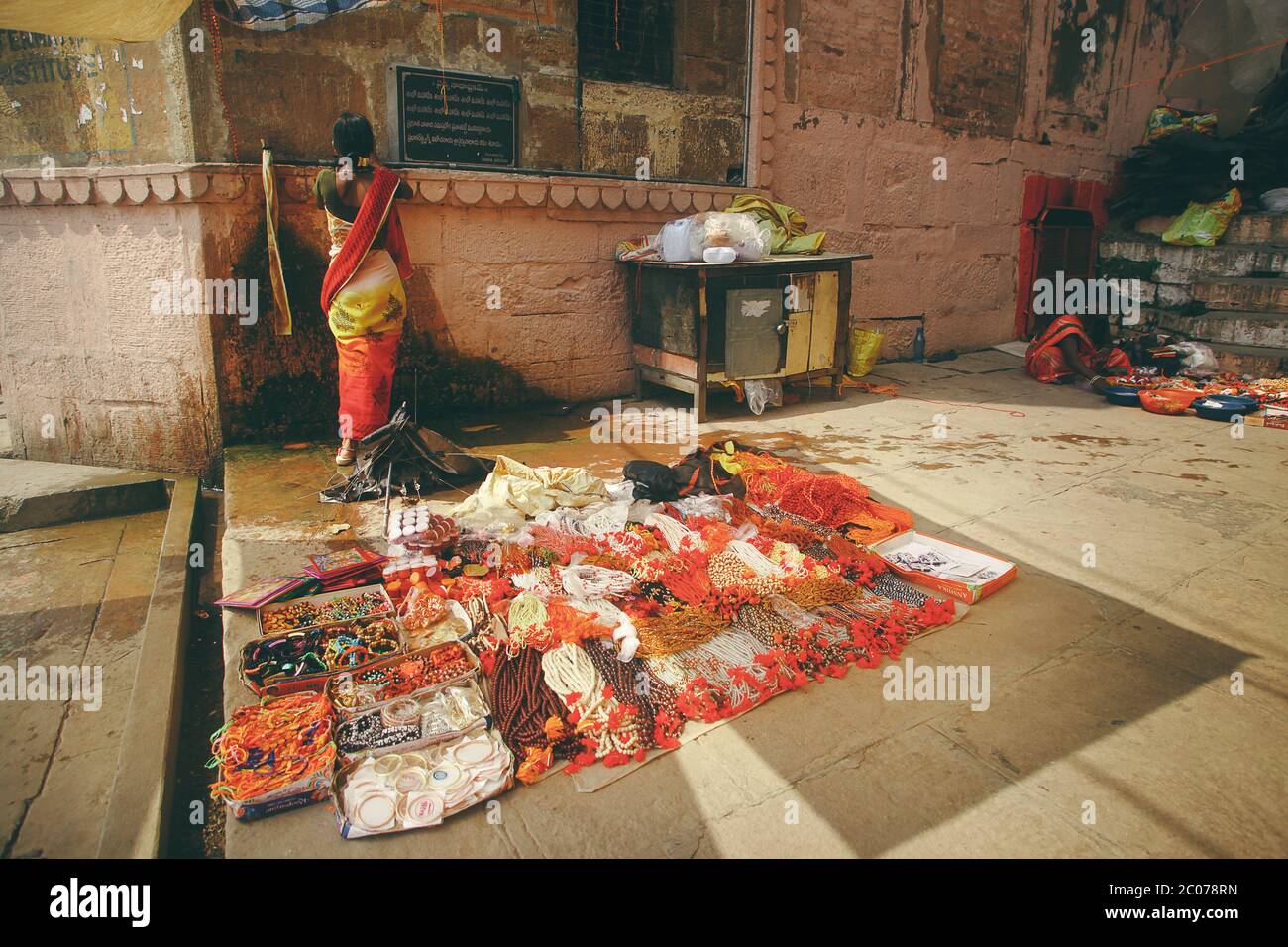 Indian woman selling some stuff Varanasi India. Stock Photo