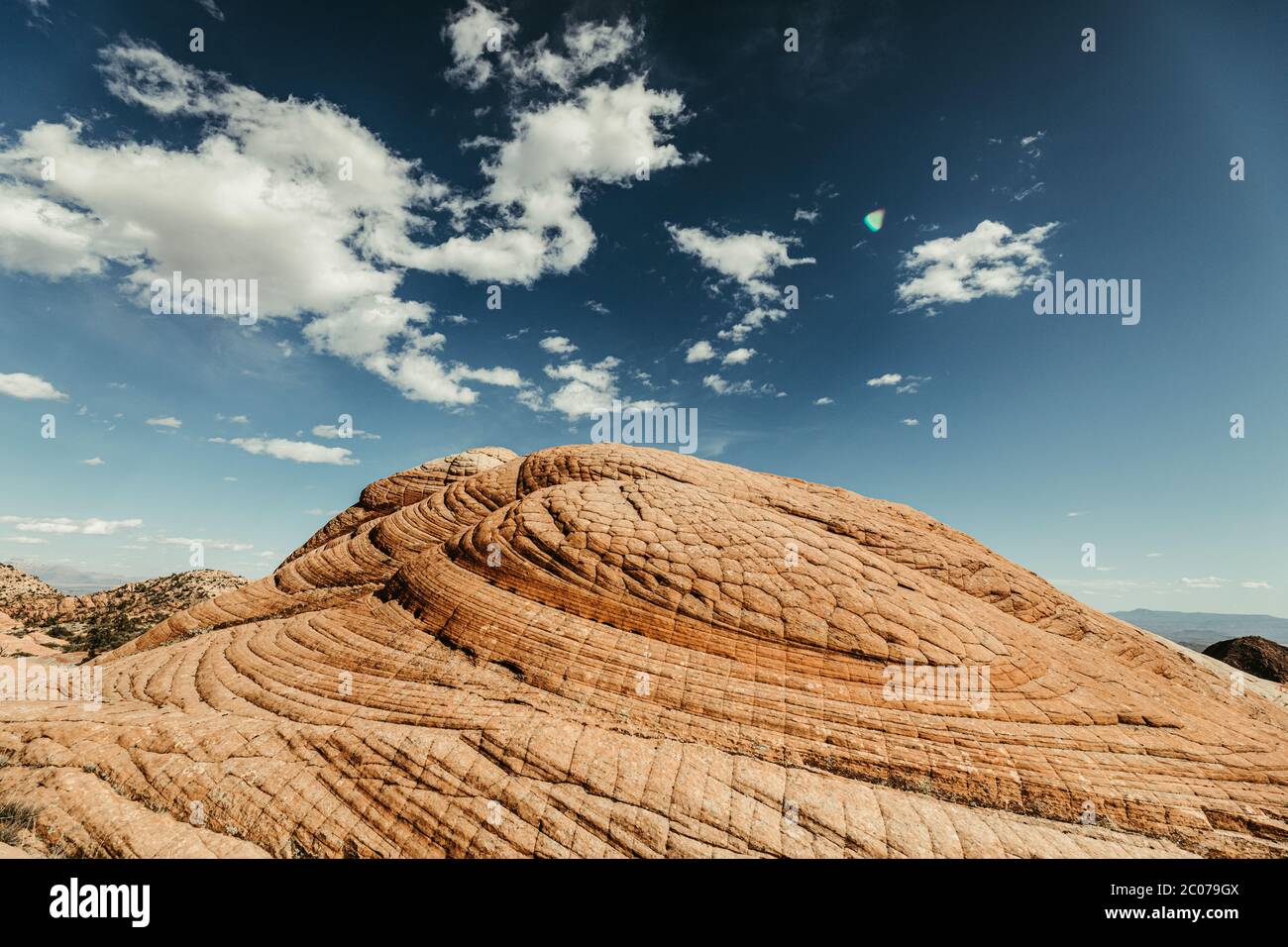 circular patterns of petrified sand dunes on red rock in utah desert Stock Photo