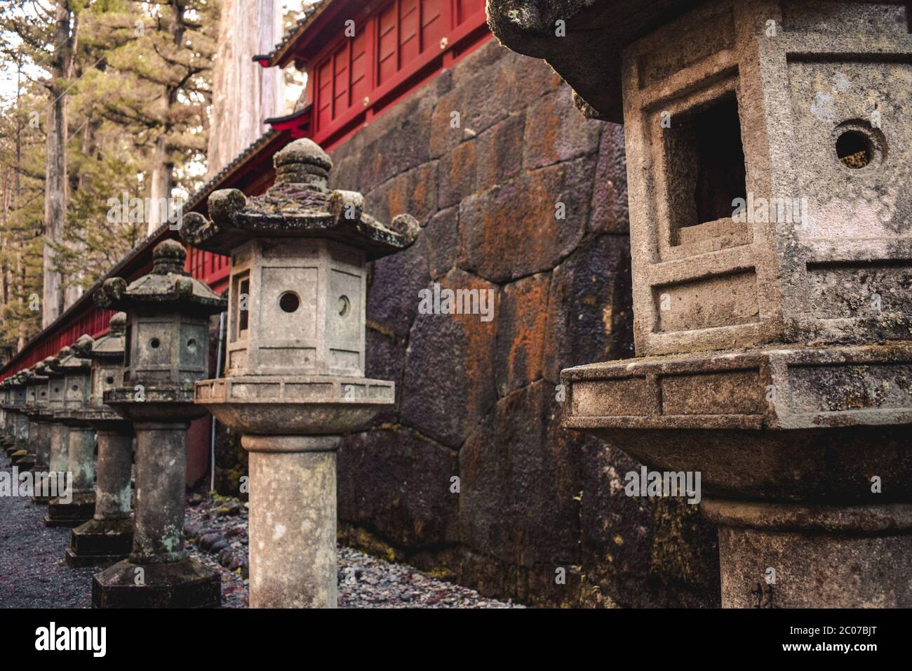 Japanese traditional stone lanterns in a row in Nikko Japan Stock Photo