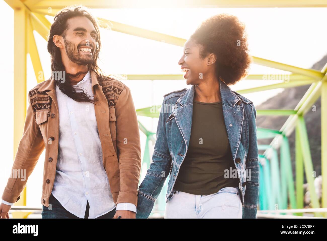 Happy smiling couple walking in city - Young lovers having fun dating outdoor - Youth people love and relationship concept Stock Photo