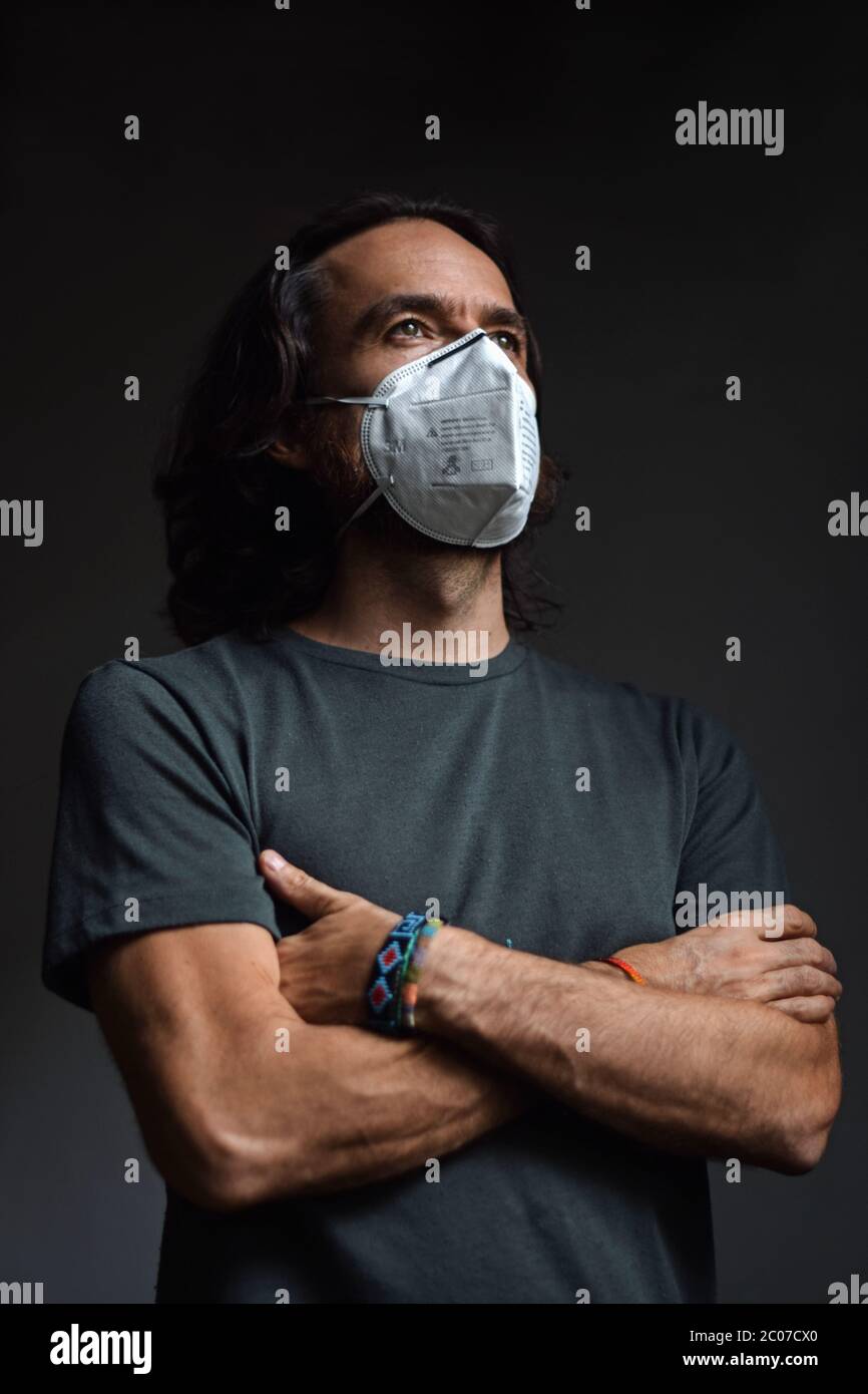 Interior portrait of caucasian man wearing a face mask and looking ...