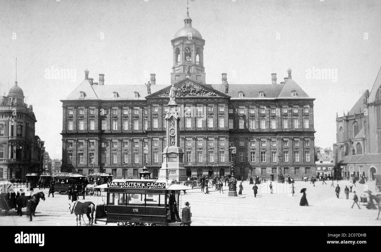 [ 1880s Netherlands - Amsterdam Dam Square  ] — The Royal Palace on the Dam Square in Amsterdam, the Netherlands.  The classical architecture style building was constructed as the city hall in 1655. The main architect was Jacob van Campen (1596–1657).  In the foreground, a horse-drawn streetcar featuring advertising for Van Houten cacao powder can be seen. This series of cars was built by the Amsterdamsche Omnibus Maatschappij in 1884.    19th century vintage albumen photograph. Stock Photo