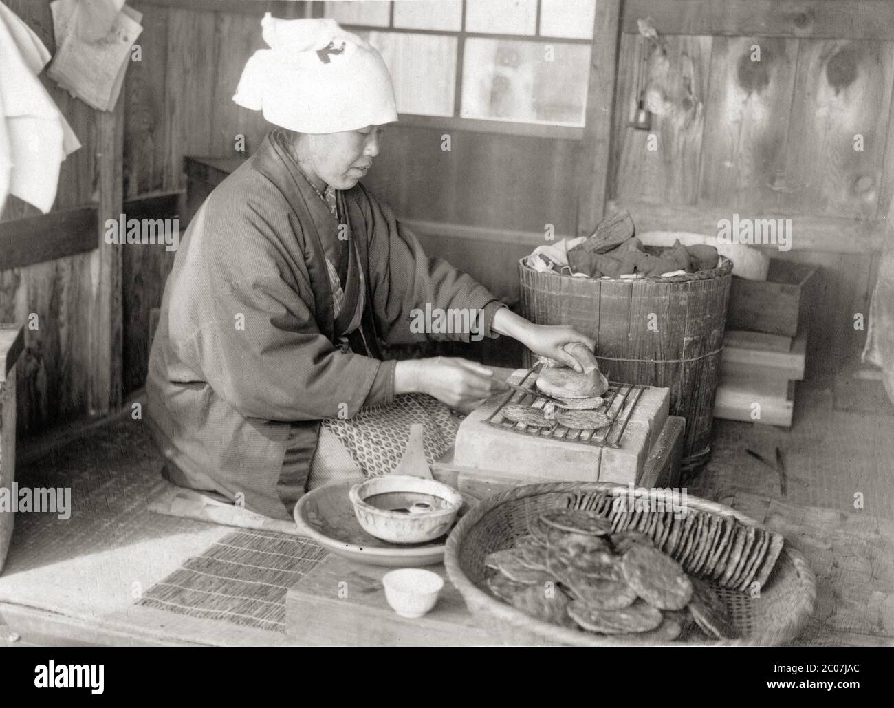 [ 1910s Japan Grilling Rice Crackers ] — Japanese woman grilling