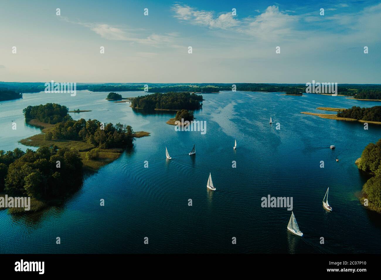 White yachts sailing in Galve lake in Trakai, Lithuania Stock Photo