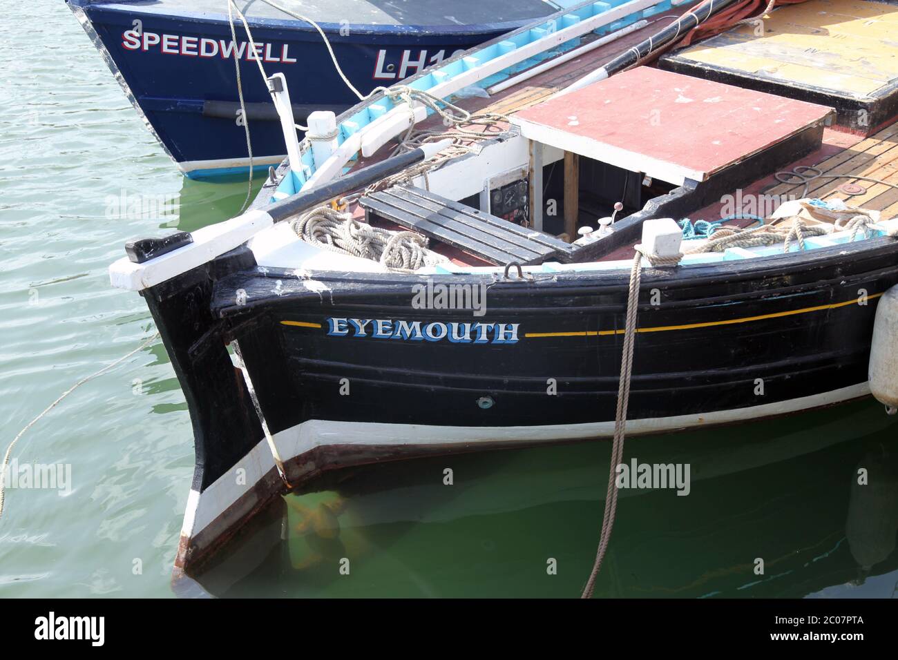 Close up of fishing boat named 'Eyemouth' and 'Speedwell' moored in harbour, Eyemouth, Scotland
