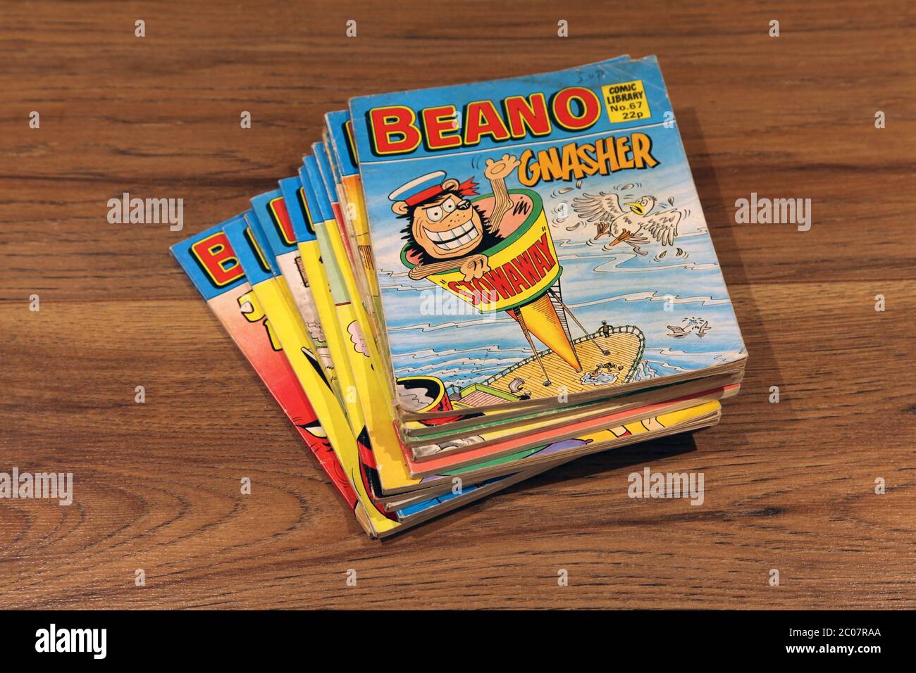 Beano Comic Library No.67 1985 "Gnasher in Stowaway" stacked in a pile of Beano comics Stock Photo