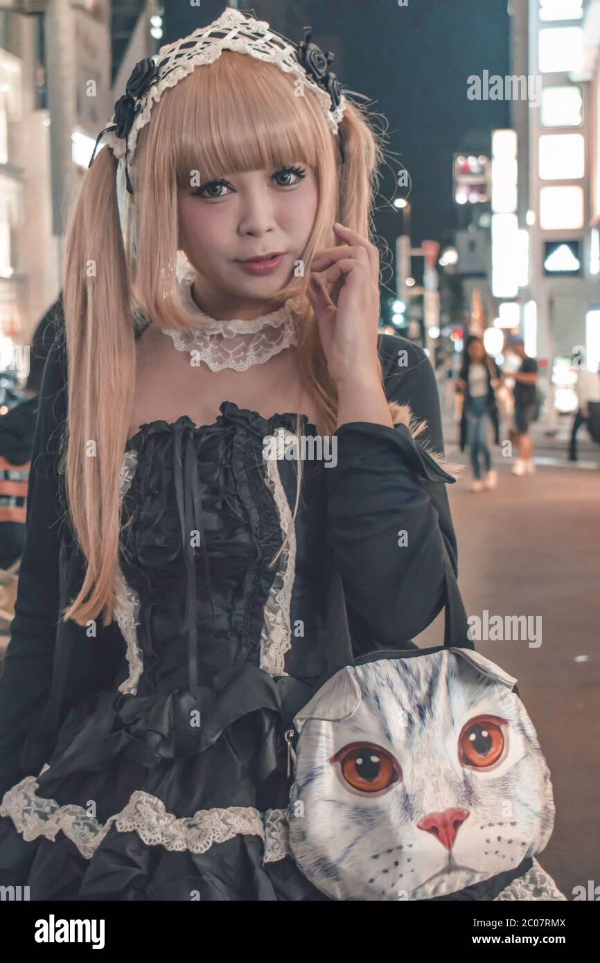 Unidentified Japanese girl in black costume and blonde dived hair walking at Harajuku in Tokyo Japan (example of typical Japanese kawai cosplay) Stock Photo