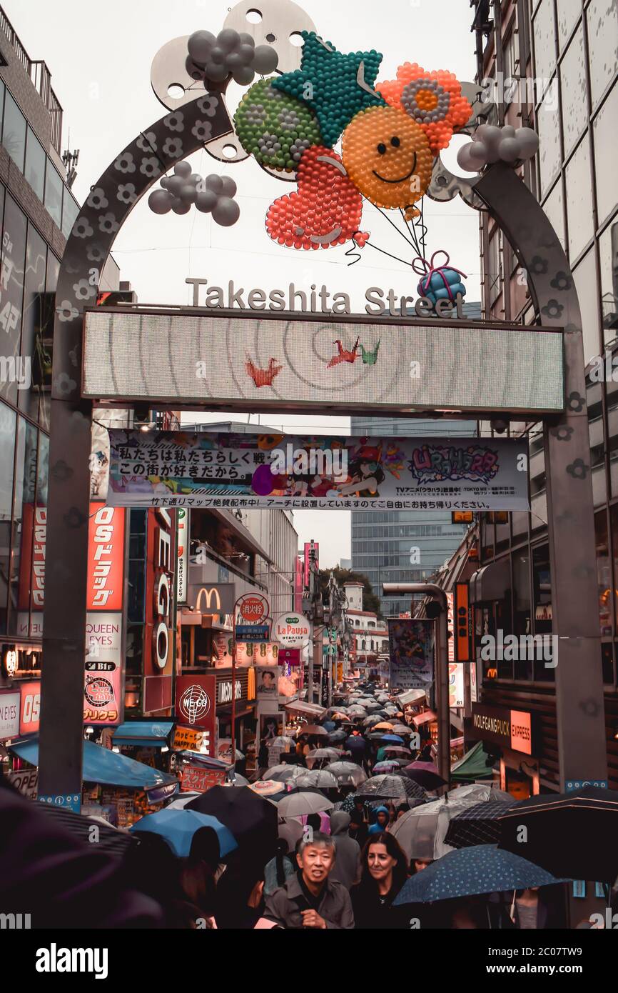 Gate to popular shopping area of the Takeshita street in Tokyo Japan during rain Stock Photo