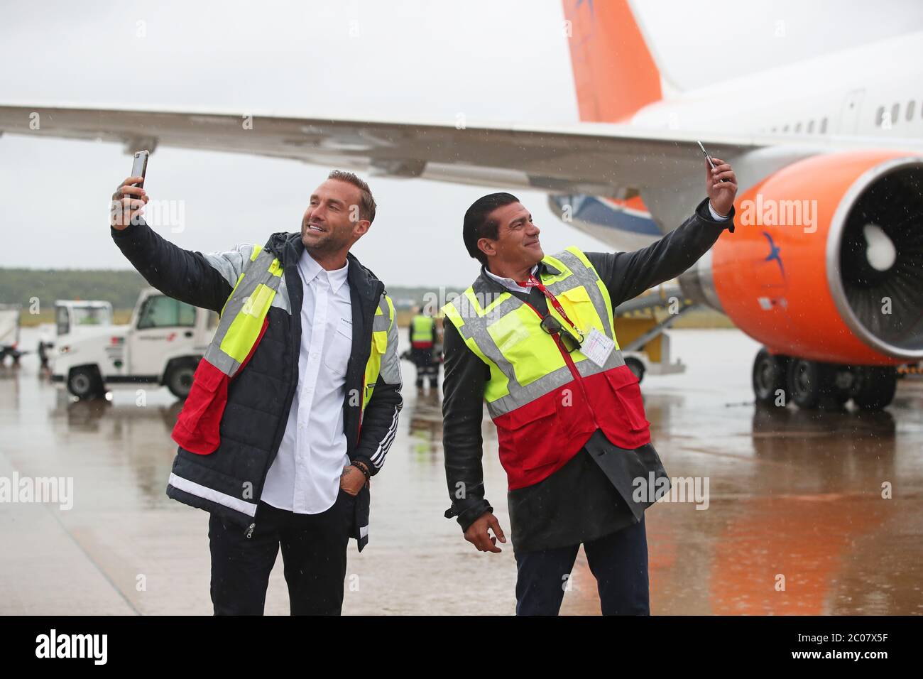 Calum Best (left) and Tamer Hassan pose for photographs as boxes of Personal Protection Equipment (PPE) are unloaded from a plane at Robin Hood Airport in Doncaster, South Yorkshire. ??30,000 worth of PPE has been donated to the Mask Our Heroes charity, which was set up by actor Tamer Hassan in the wake of the coronavirus outbreak to help supply frontline NHS and health workers with the protective equipment they need. Stock Photo