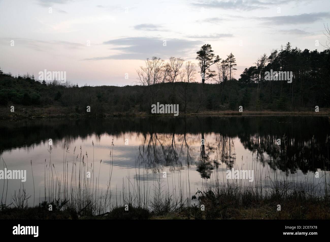 Muncaster Tarn in the Western English Lake District at sunset Stock Photo