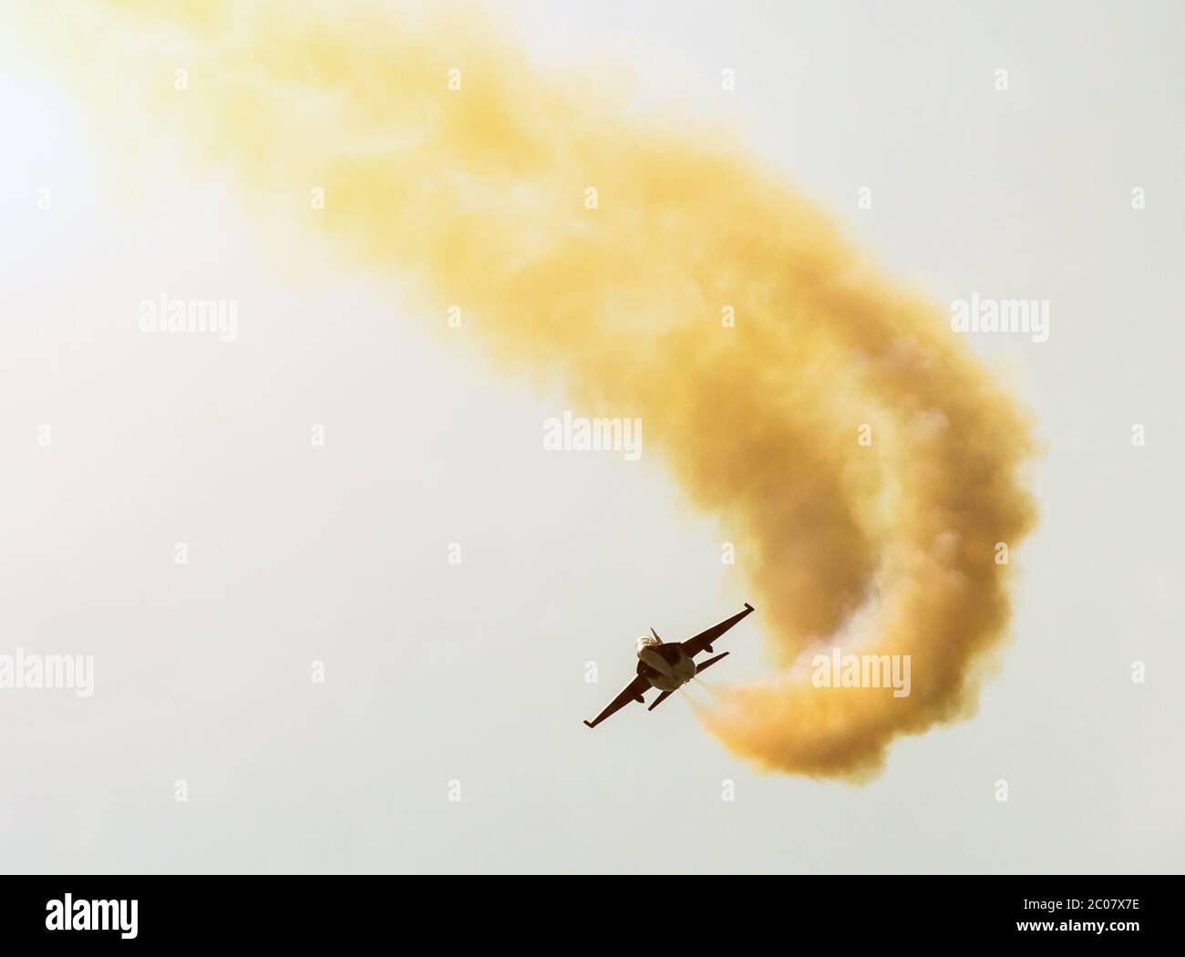 One fighter against the background of the sun and clouds performed a figure of aerobatics Stock Photo