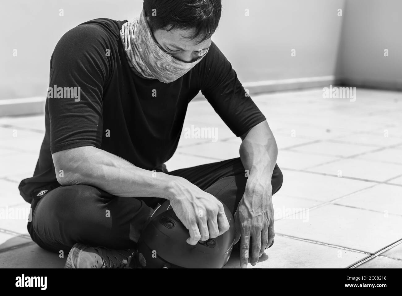 Protester sitting on the sidewalk with his head down, exhausted and sad. Stock Photo