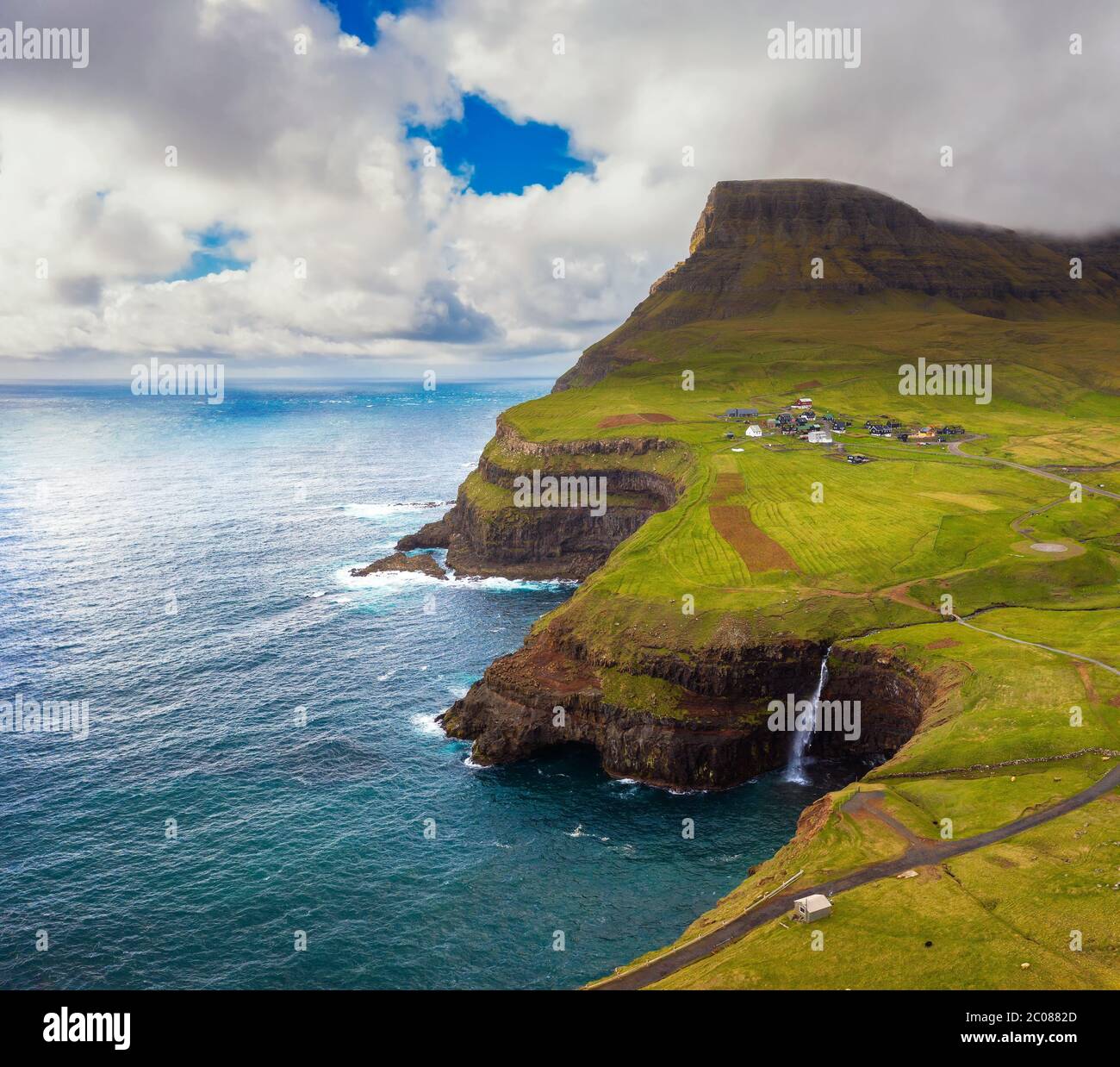 Aerial view of Gasadalur village and its waterfall in Faroe Islands, Denmark Stock Photo