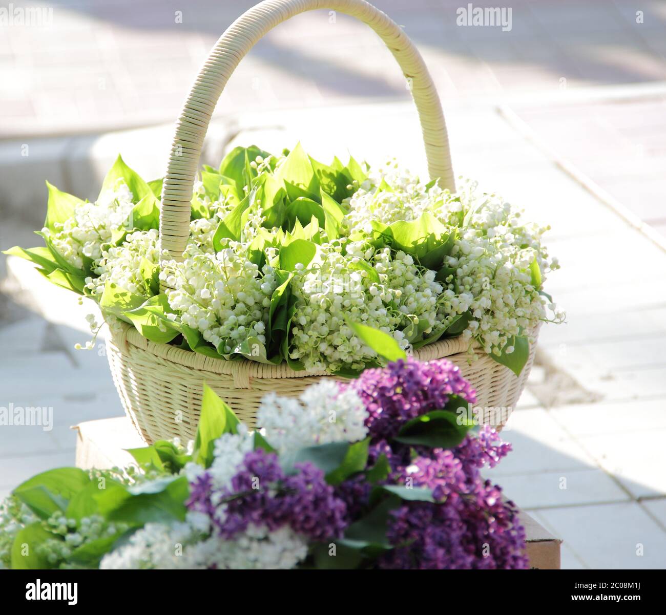 Bouquets from lilies of the valley in a wattled basket Stock Photo - Alamy