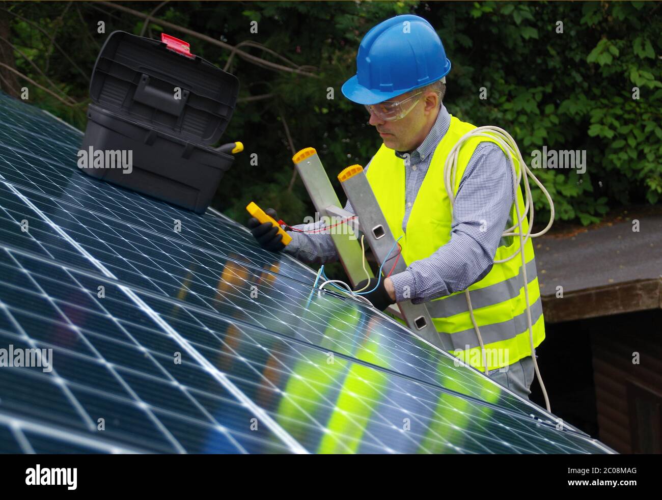 Installation and commissioning of solar panels. Renewable energy in a private home. Worker with