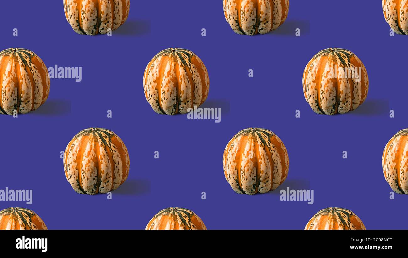 Seamless Pattern with with yellow pumpkin on purple background. Stock Photo