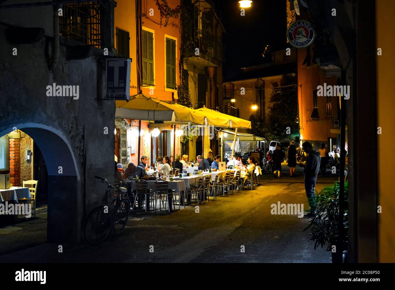 Late night in the village of Monterosso Al Mare, part of the Cinque Terre in Italy on the Italian Riviera as tourists enjoy an evening sidewalk cafe Stock Photo