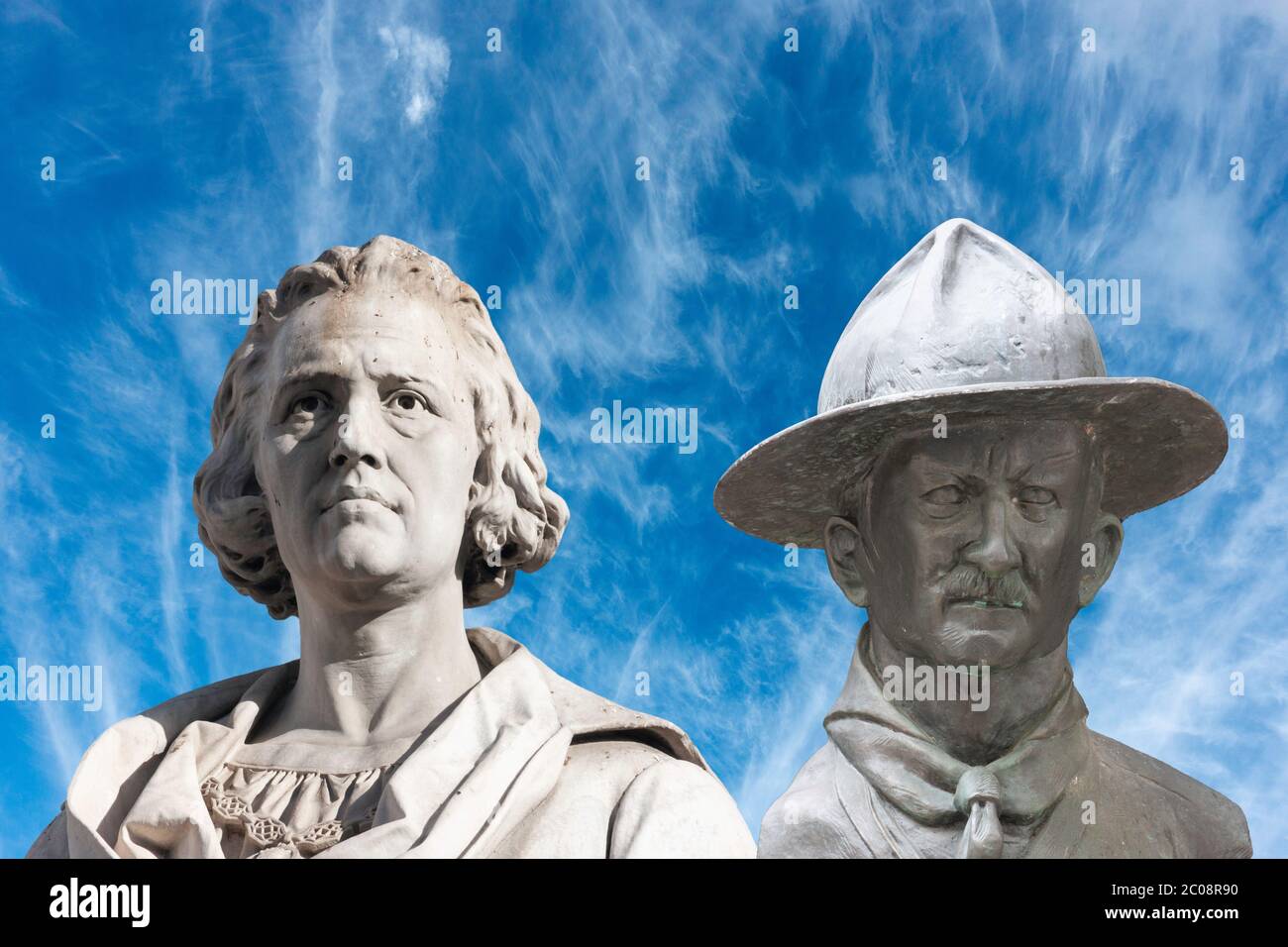 Statue, sculpture of Christopher Columbus and Lord Baden Powell overlayed against blue sky. Stock Photo