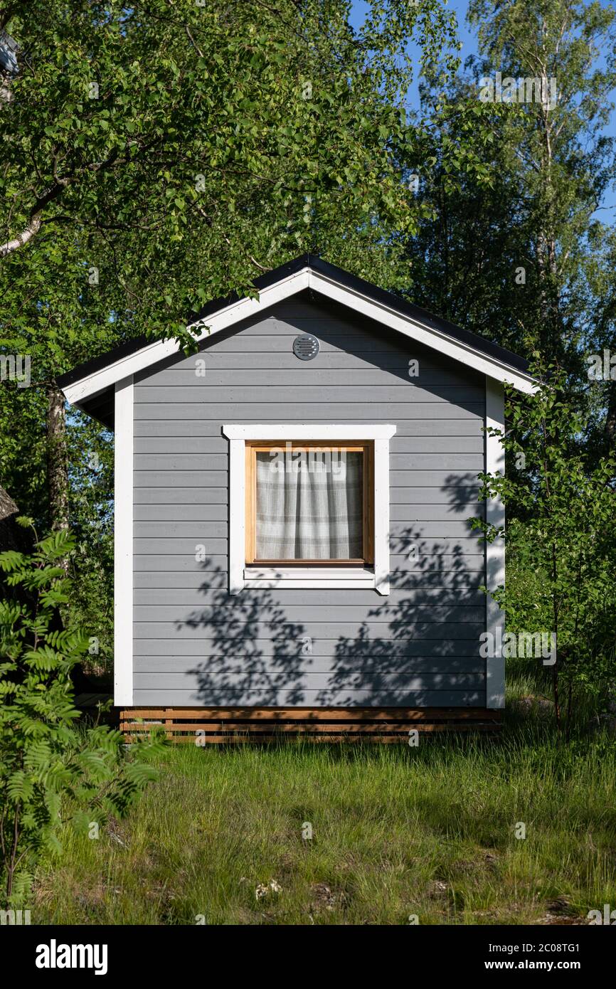 Little grey summer cottage or summer hut in Kivinokka summer camp area of Helsinki, Finland Stock Photo