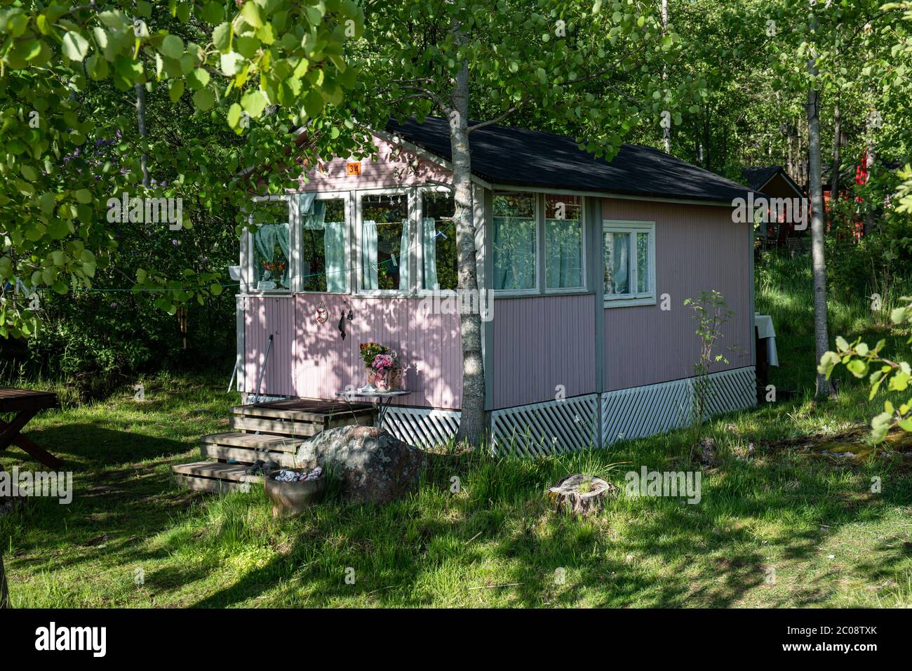 Little pink summer cottage or hut in Kivinokka summer camp area in Helsinki, Finland Stock Photo