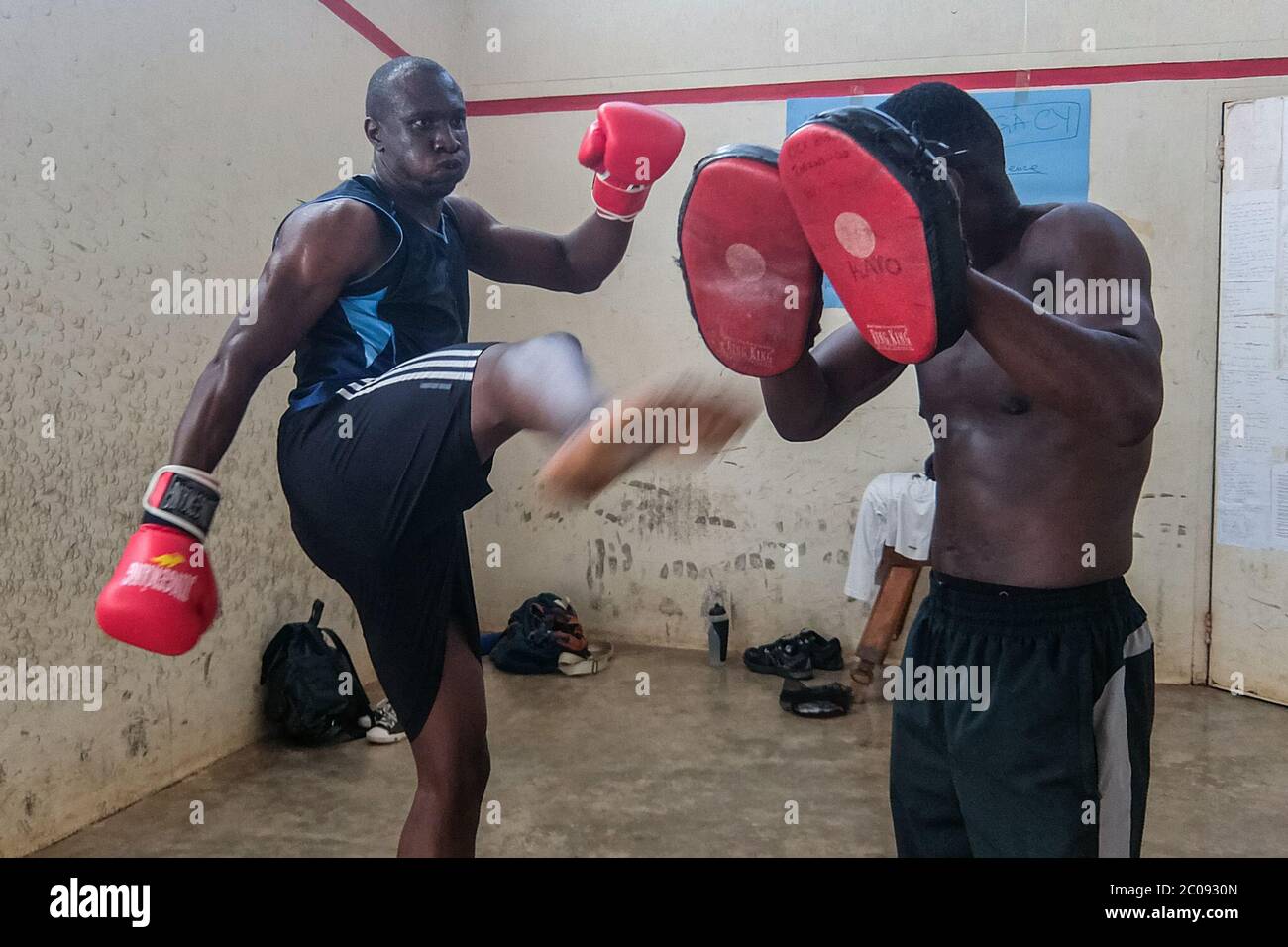Hannington Mulumba practices kicks during a kick boxing training session with his coach, Kato Isaac, at Makerere University in Kampala, Uganda. (Edna Namara, GPJ Uganda) Stock Photo