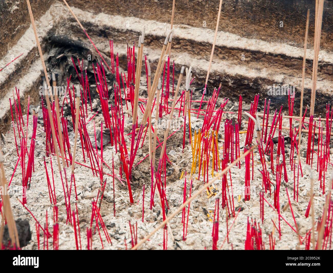 Pink incense sticks in ash, buddhist temple Stock Photo Alamy