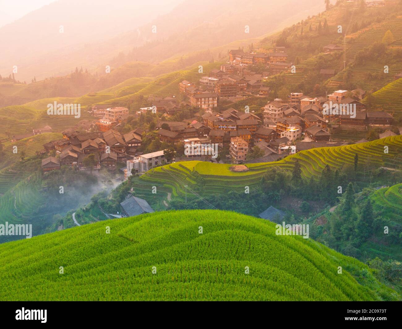 Traditional chinese village wooden houses in the middle of rice terraces, Pingan, Guangxi, China Stock Photo