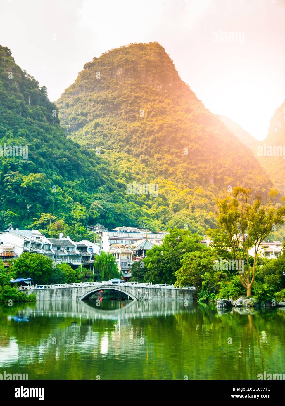 Small bridge over water and green peaks at Yangshuo, Guangxi Province, China. Stock Photo