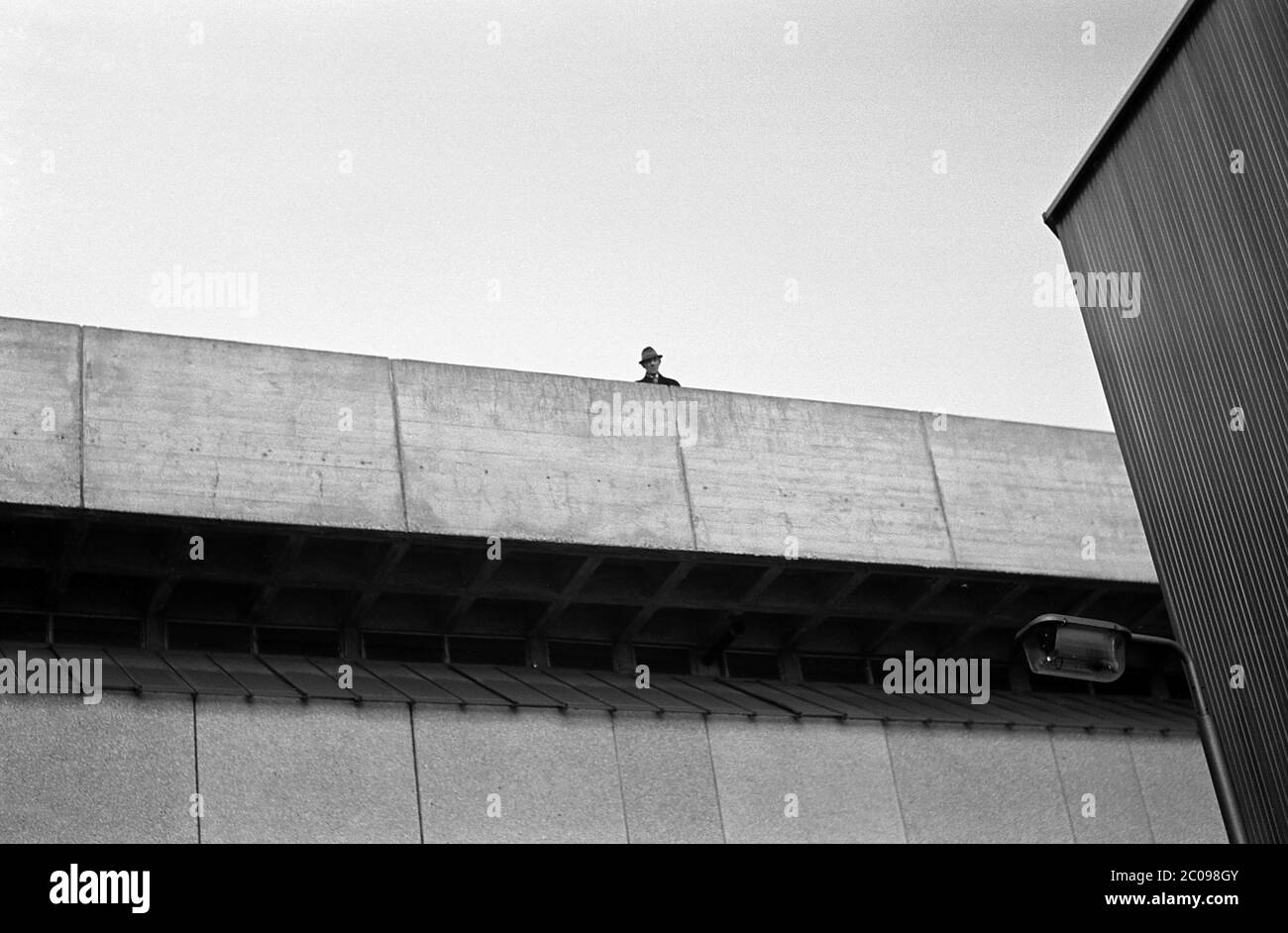 AJAXNETPHOTO. 10TH MARCH, 1968. PORTSMOUTH, ENGLAND. - 2ND UGLIEST - MAN LOOKS OUT OVER PARAPIT OF TRICORN COMPLEX NEAR COMMERCIAL ROAD. CONCRETE BUILDING ONCE VOTED 2ND UGLIEST IN BRITAIN. NOW (2020) DEMOLISHED.PHOTO:JONATHAN EASTLAND/AJAX REF:3568138 3 96 Stock Photo