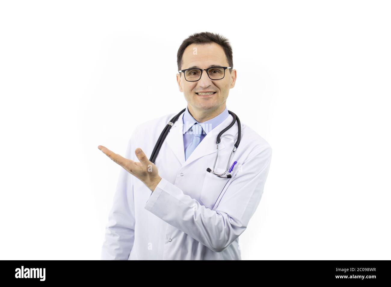 Doctor with fake smile pointing at empty text space isolated on white background Stock Photo