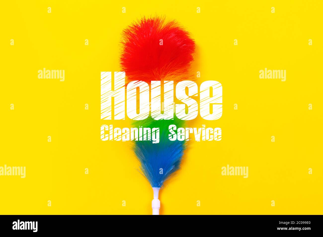 Colorful feather duster on yellow background, tool with inscription
