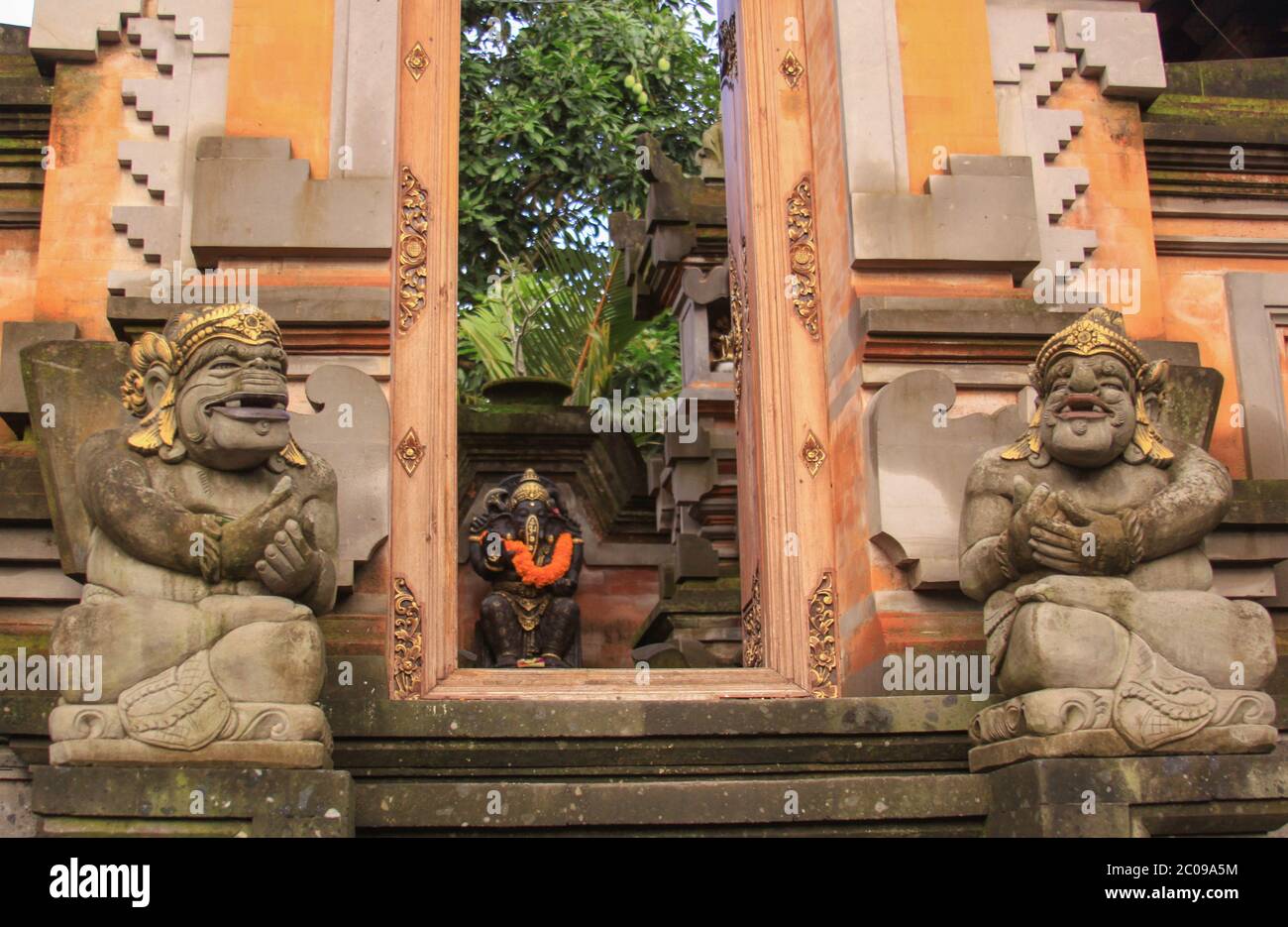 Door or gate to enter into traditional balinese garden architecture detail. Open style pavilion or local pavilion called bale in the garden. Travel ph Stock Photo