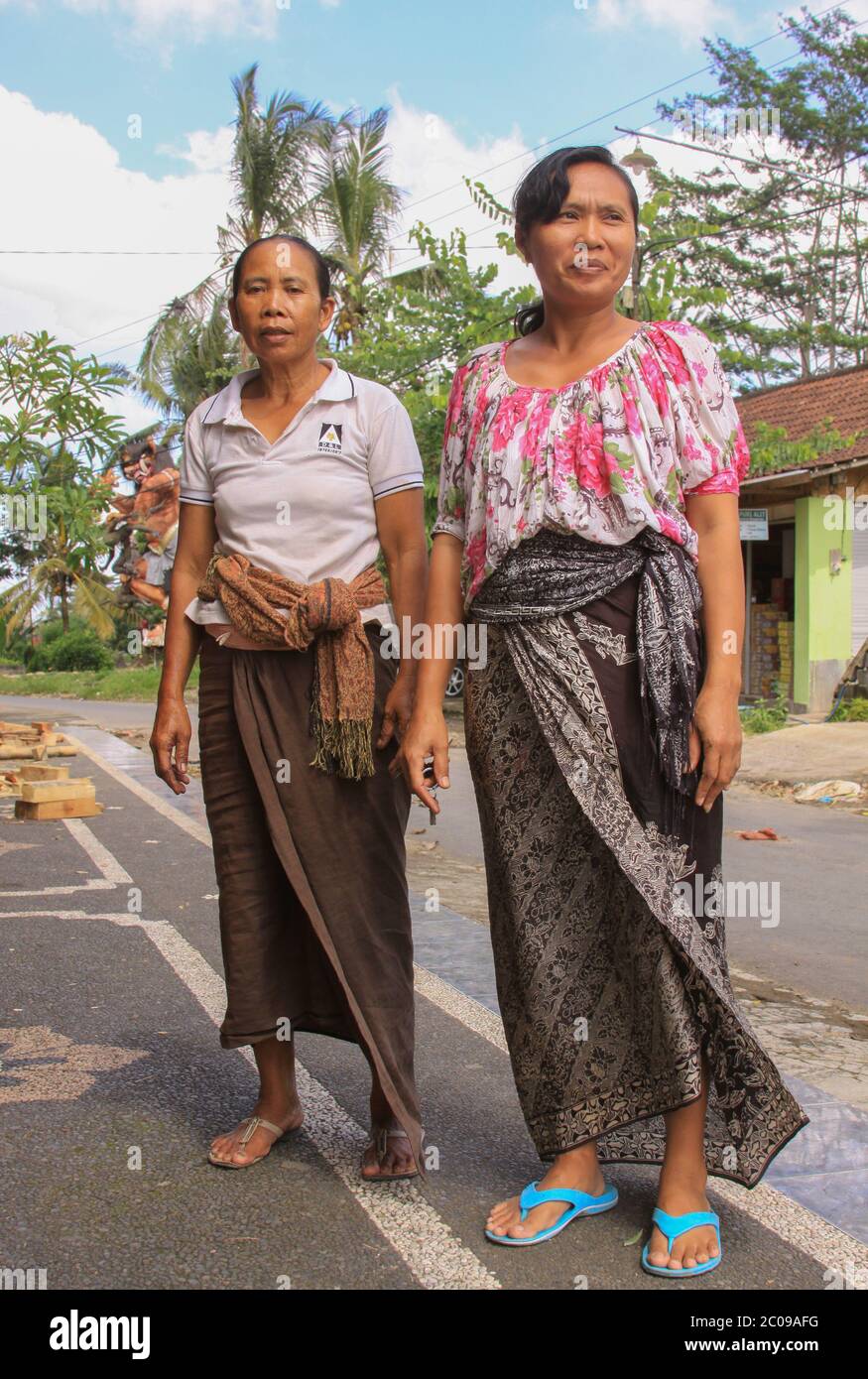 Local balinese women in Bali, Indonesia, dressed in batik dress for  festivity Stock Photo - Alamy
