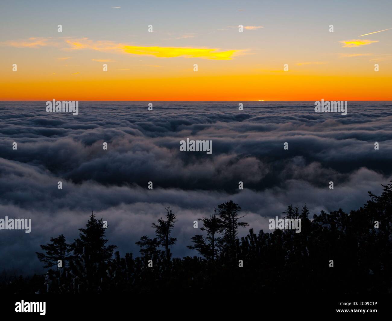 Winter inversion clouds in the mounains at sunset time Stock Photo